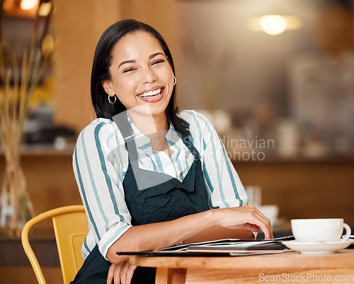 Image of Coffee shop owner looking proud and happy while doing paperwork and having coffee break. Young business woman checking stock, orders and inventory, enjoying her career. Positive lady managing a cafe