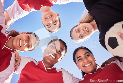 Image of A soccer team of females only in a huddle during a match happy about winning the competition. Low angle portrait of a womens football squad standing in a circle in unity and support as game strategy