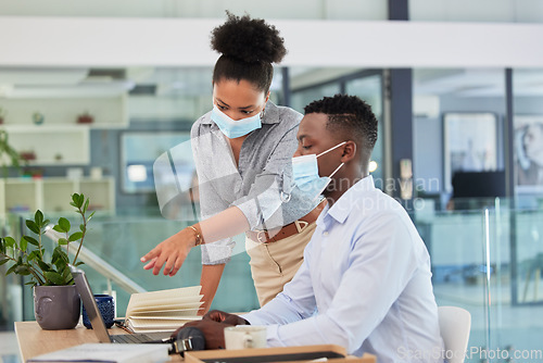 Image of Covid, masks and safety in the workplace of business people working together during a pandemic in an office. Manager, trainer or mentor training businessman how to use software on laptop.