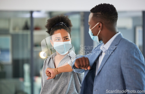 Image of Covid, colleagues and greeting by touching elbows and wearing face masks and social distancing in an office. Friendly and diverse entrepreneurs preventing coronavirus infection spread at a workplace