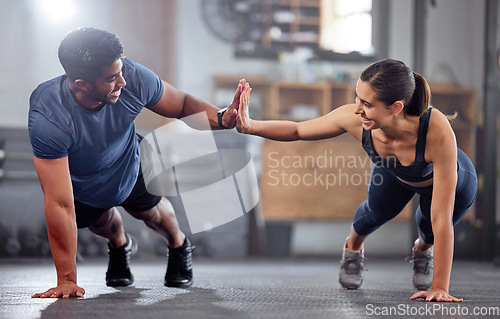 Image of Fitness, motivation and high five while doing push ups and exercising together at the gym. Healthy, fit and athletic couple goals while enjoying a training session with teamwork at a health club