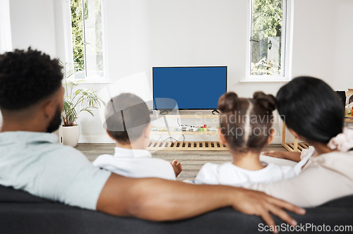 Image of Watching tv or streaming a subscription service with green screen and chromakey together as a family at home. Rearview of mother, father and children getting ready to watch a movie or series