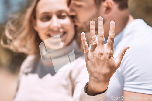 Image of Closeup hand of proposal engagement ring after romantic, caring and loving man proposes to woman. Happy, smiling and excited couple showing wedding band while hugging, embracing or holding each other