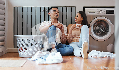 Image of Couple, chores and laundry while doing home cleaning and feeling happy while talking and relaxing together. Boyfriend and girlfriend with healthy communication while sitting together on wash day