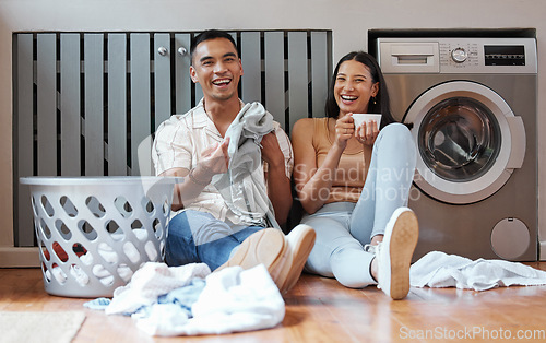 Image of Happy, relaxed and responsible couple doing laundry, household chores or cleaning together on the weekend at home. Young millennial boyfriend and girlfriend enjoying their new modern washing machine