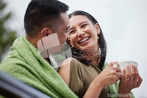 Image of Cozy, smiling and romantic young couple cuddling and relaxing with blanket in cold winter. Loving husband and wife laughing and enjoying dating relationship bonding time in outdoors nature