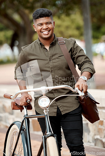 Image of Happy business man riding a bicycle, commuting and staying active while traveling in city. Portrait of a smiling, cheerful and positive guy cycling on a bike and being carbon neutral at a park