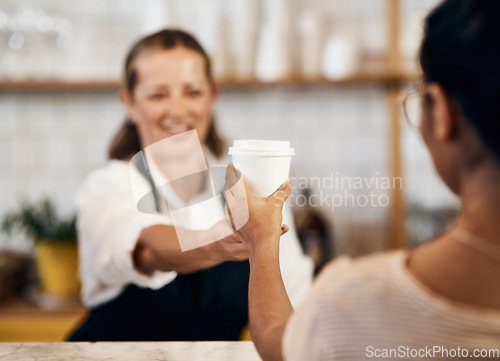 Image of Customer buying a hot cup of coffee from a happy barista giving good and friendly service at a local cafe shop. Smiling startup entrepreneur and owner handing a drink in a tea store