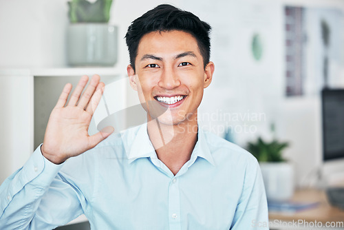 Image of Happy business man greeting, waving and saying hello with hand gesture while smiling and looking friendly in an office. Portrait of asian entrepreneur saying thank you or welcome during testimonial