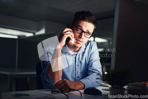 Image of Stressed, overworked and worried while talking on phone to solve problem while working late night at the office. Serious and exhausted man calling IT about computer issue trying to reach deadline