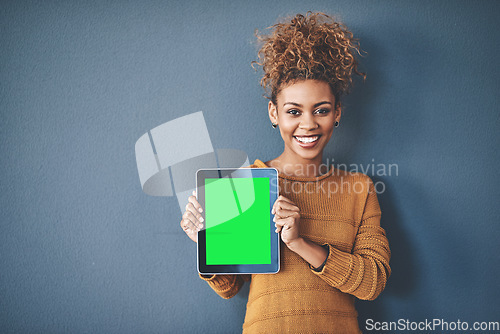 Image of African female holding green screen tablet copyspace. Cute, attractive and smiling young afro woman standing and showing a mobile device.Happy, cheerful and ethnic woman after buying new app.
