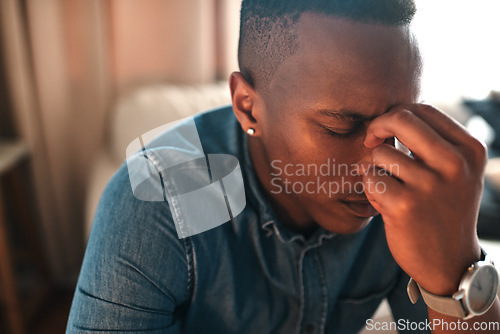 Image of Stressed, tired businessman with headache alone at home. Man having eye tension or strain from overworking, burnout and anxiety. Depressed male having problems at work, suffering from lack of sleep.