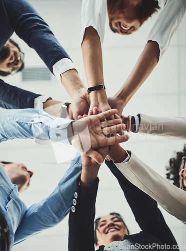 Image of Teamwork, collaboration and unity between business people with their hands stacked for project development and innovation. Group of corporate colleagues united, joining or working together from below