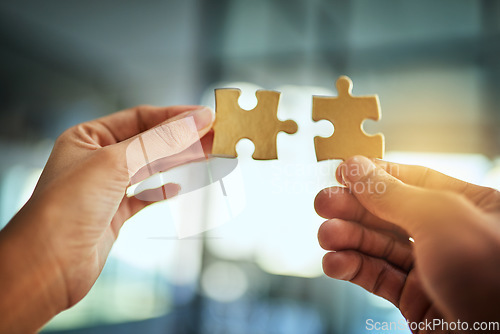 Image of Puzzle, teamwork and innovation while people fit jigsaw pieces together in an office. Business solution, strategy and success while plans come together. Connection, partnership and building trust