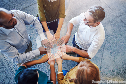 Image of Fun, collaboration and teamwork in hands linking during team building by diverse group of business people. Above happy investors showing support, trust and motivation while huddling, joining together