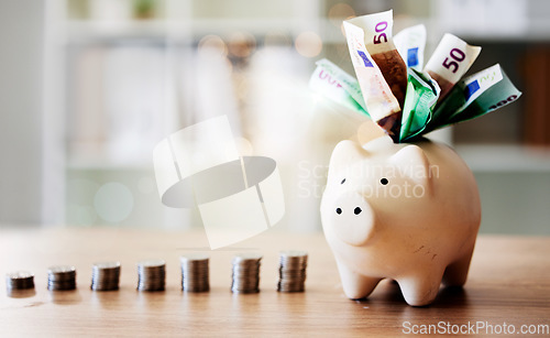 Image of Banking, finance and investment in piggybank for future savings, budget and insurance on a table. Closeup of tool to save with cash notes and coins from investing for the future and financial growth