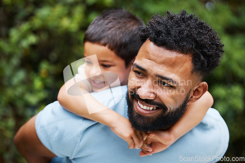 Image of Happy father with son on piggyback while smiling, laughing and playing in a park outdoors. Cheerful, loving and caring dad relaxing, bonding and enjoying fun day with playful, cute and adorable boy