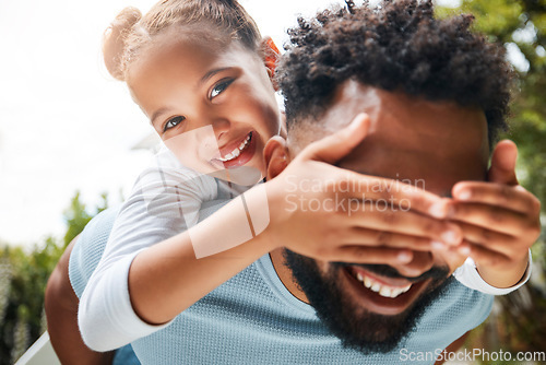 Image of Happy, playful and carefree dad and daughter playing outdoors in the park and child covering fathers eyes. Portrait of an excited, joyful and cheerful child having fun with her parent in nature