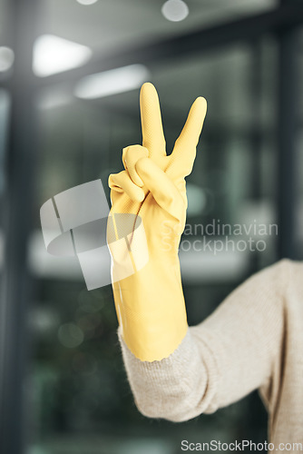 Image of Peace sign, carefree, and hand gesture while cleaning, doing chores and housework alone at home. Closeup of fingers of a cleaner counting, expressing happiness and enjoying a hygiene task