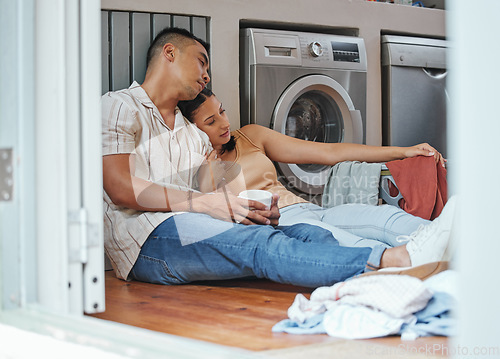 Image of Couple, chores and laundry while doing home cleaning wile feeling tired and relaxing together. Loving boyfriend and girlfriend with a healthy relationship while sitting together on wash day