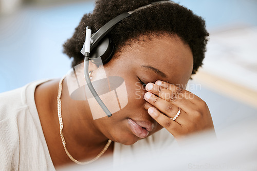 Image of Stress, tired and headache with a call center agent feeling pressure and anxiety while working in a demanding office. Overworked, exhausted consultant mentally frustrated with burnout and depression