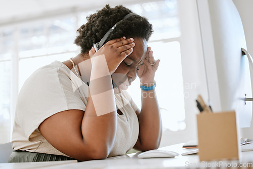 Image of Stressed, tired and with a headache call center agent feeling pressure and anxiety while working in a demanding office. Overworked, exhausted consultant mentally frustrated with burnout and depressed