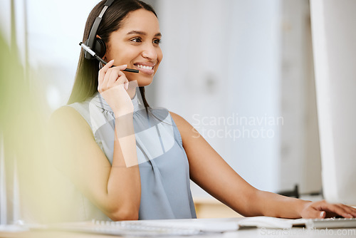 Image of Call center agent, business consultant or telemarketer assisting client online using headset while typing at computer desk. Contact us for excellent customer service or online faq helpdesk support.