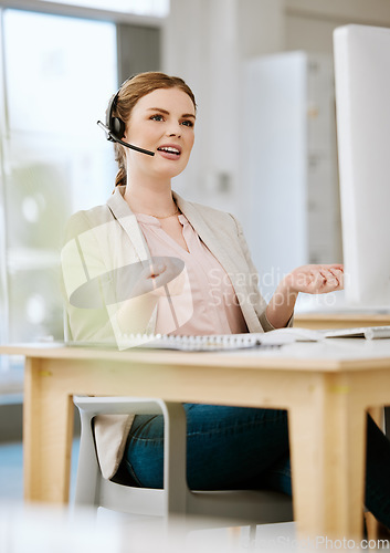 Image of Insurance agent, call center or contact support employee giving good customer service via her headset at her help desk at work. Female advisor consulting and helping via her headset talking about us