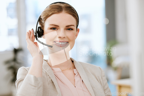 Image of Smiling, friendly call center agent with headset for online consulting in an IT tech agency. Face of female support professional offering virtual assistance to web user or contact us hotline at work.