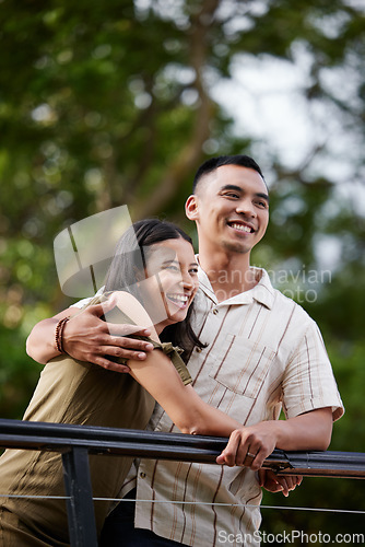Image of Stylish, loving and carefree couple bonding and hugging showing affection in the park. Happy, cheerful and romantic african american couple embracing each other while standing and laughing outdoors
