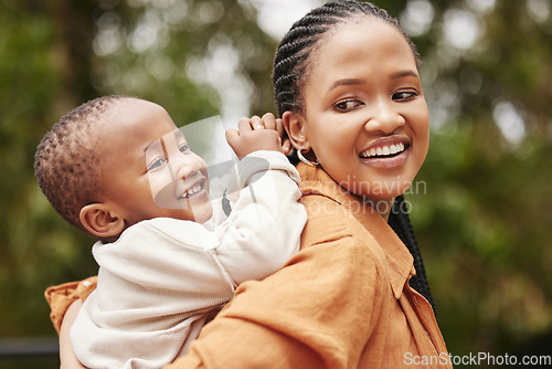 Image of Happy mother bonding with cute baby boy on piggyback while smiling, laughing and having fun play in a park outdoors. Cheerful, loving and caring mom relaxing with playful, cute and adorable child