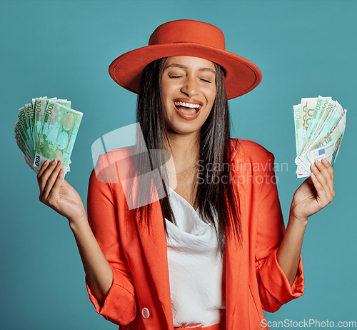 Image of Money, currency and winning the lottery with a young woman holding cash and looking happy, excited and celebrating success. Female cheering with income, savings or a return on investment in her hands