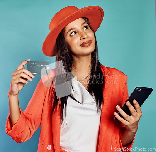 Image of Credit card, online shopping and trendy woman with style typing in banking information to use a money service. Fashionable, stylish and edgy shopper thinking of buying modern clothes and new styles