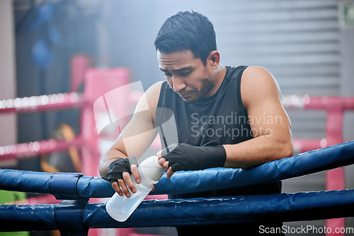 Image of Sad, lose and defeated athlete looking tired after workout, unhappy and drinking water after boxing for fitness. Young, sporty and Asian man breathing heavily, resting and taking break from exercise