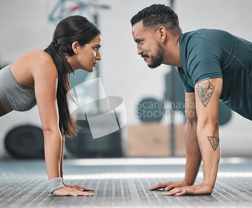 Image of Fitness, gym and training couple doing an exercise workout and living an active, healthy and sporty lifestyle together. Serious, toned and athletic young friends using teamwork to get a stronger body