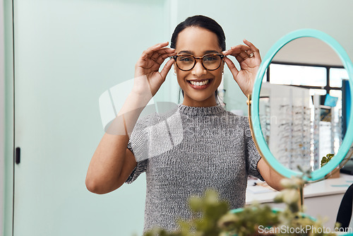 Image of Woman wearing pair of trendy glasses, stylish spectacles and new prescription lenses at an optometrist. Portrait of a customer choosing, buying and shopping for frames for better vision and eyesight
