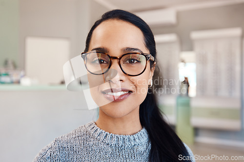 Image of New glasses at optometrist checkup, buying eyewear and fitting frames at a shop. Closeup portrait of the face of female doing eyecare, examining eyesight and standing at optician consultation