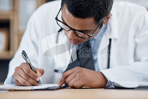 Image of Doctor writing a prescription, survey or medical care paperwork for a patient at the hospital. A healthcare professional writing a patient information chart. A GP filing a document in an office
