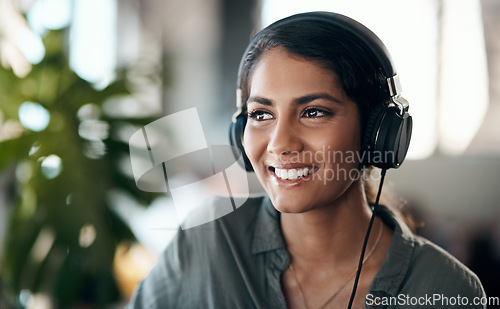 Image of Happy face of young woman listening to music on headphones, happy and relaxed at home. Female smiling while spending her free time enjoying an audio book or learning a new language on the weekend