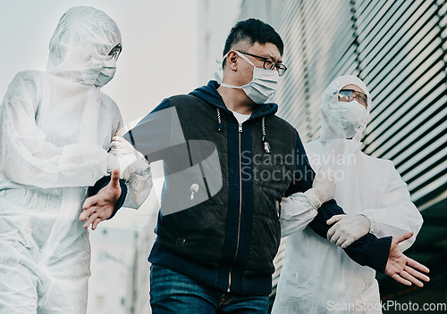 Image of Man breaking covid regulation getting taken away or arrested by healthcare workers wearing hazmat protective suits. Male removed for not following the rules or restrictions of coronavirus pandemic.
