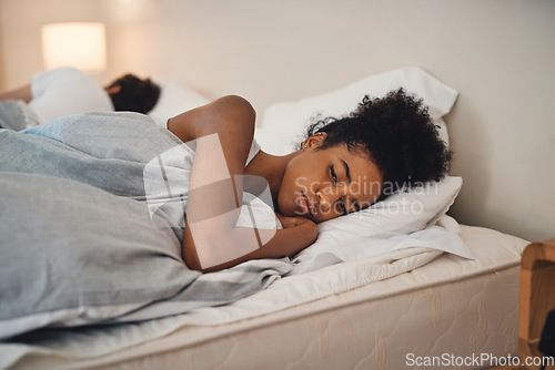 Image of Sad, bad sleep and insomnia of a woman having relationship issues at home. Upset female or couple in the bedroom after having an argument. Depressed lady in thought and conflict with her husband.