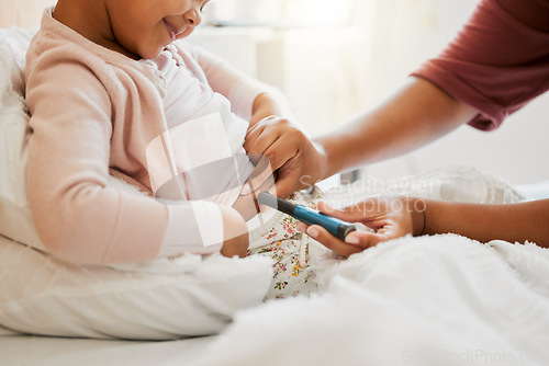 Image of Testing glucose, blood pressure and diabetes of little girl with insulin treatment in bed at home. Mother checking health, wellness and blood sugar medical measurement of her daughter in a bedroom