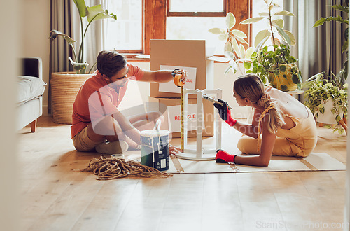 Image of Couple painting wooden table by recycle, donate and thrift furniture for a new home improvement project in new apartment. Creative and DIY man and woman with reusable objects, decorating their house