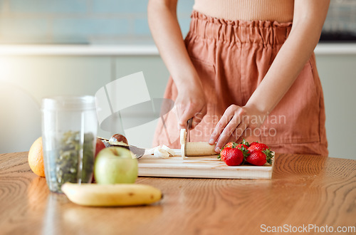 Image of Woman making healthy smoothie for energy, nutrition and wellness with fresh organic fruit being cut, sliced and prepared. Delicious detox drink, wholesome diet and cleanse with vitamins and nutrients