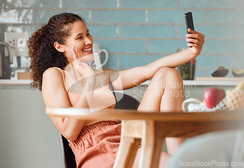 Image of Woman waving on video call with phone, greeting and talking in online chat with webcam at home. Smiling, happy and relaxed female having conversation while connecting with virtual contact on internet