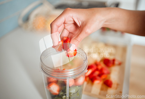 Image of Healthy, diet and fruits while preparing a smoothie or shake in a blender at home. Making a fresh homemade organic drink with strawberries to cleanse and provide energy for vitality and health