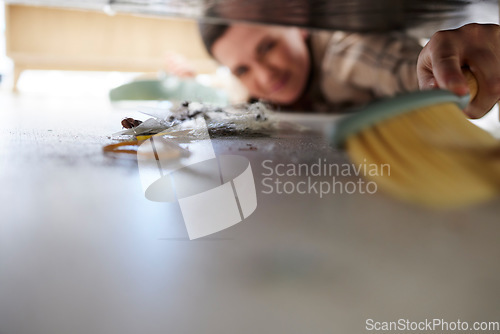 Image of Cleaning the floor, doing chores and sweeping dust or dirt from under a bed. Domestic worker, maid or stay at home mom using a broom, housework and hygiene equipment to keep a clean house