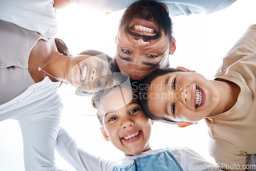 Image of Huddled family bonding, laughing and having fun while standing in a circle with heads in the middle. Below playful portrait of excited, happy and cheerful mother, father and children close together