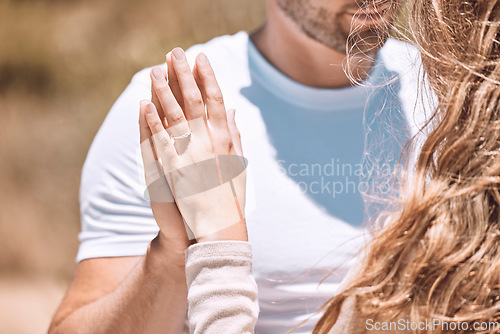 Image of Closeup of an engaged couple holding hands showing their romance, love and care. Caucasian man and woman after a sweet, romantic and special proposal. Lady showing off her beautiful engagement ring.