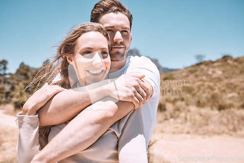 Image of Romantic, happy and in love young couple hugging together in outdoors nature walk, enjoying dating relationship and bonding time. Loving husband and wife holding each other in sweet caring embrace